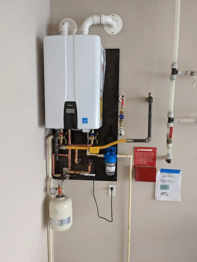 Professional plumber installing copper piping in a Dewey home